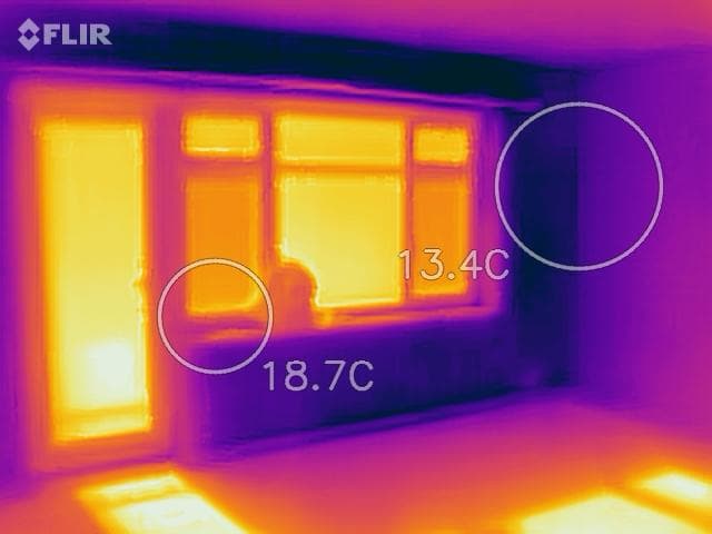 A thermal imaging camera being used during a Brighton Damp Proofers survey to locate moisture behind a wall